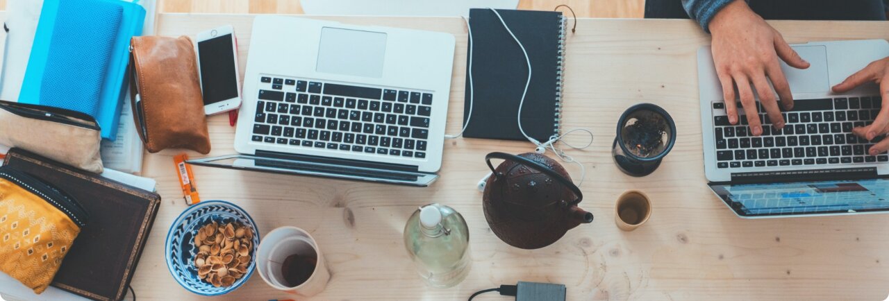 Laptops and notebooks on a shared work table